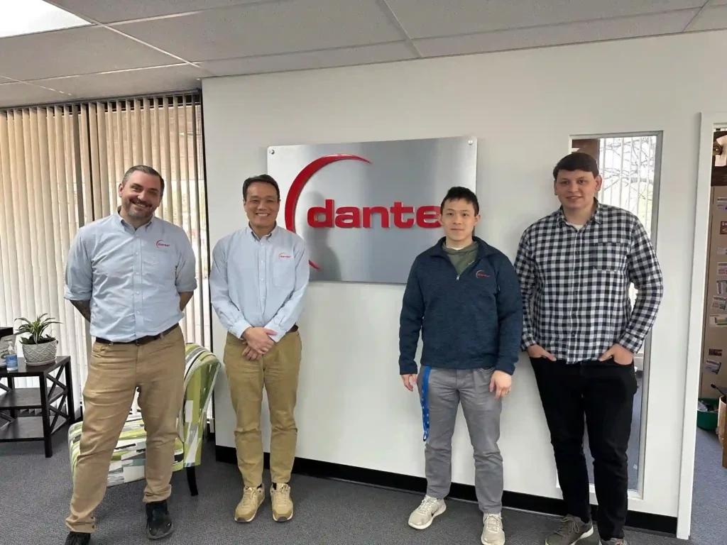 photo of jason meyer, zhichao charlie li, eddy lee, and stefan habean in the dante solutions office near the dante solutions logo